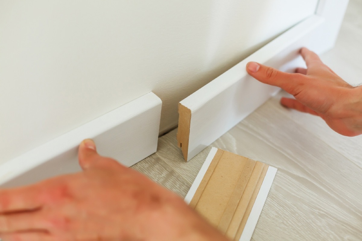 man installing baseboards, signs your home is falling apart