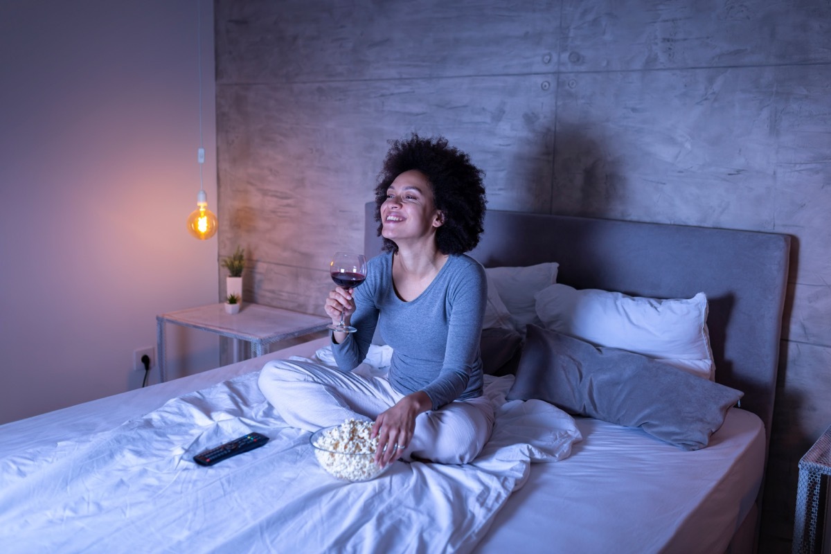 Woman watching TV in bed