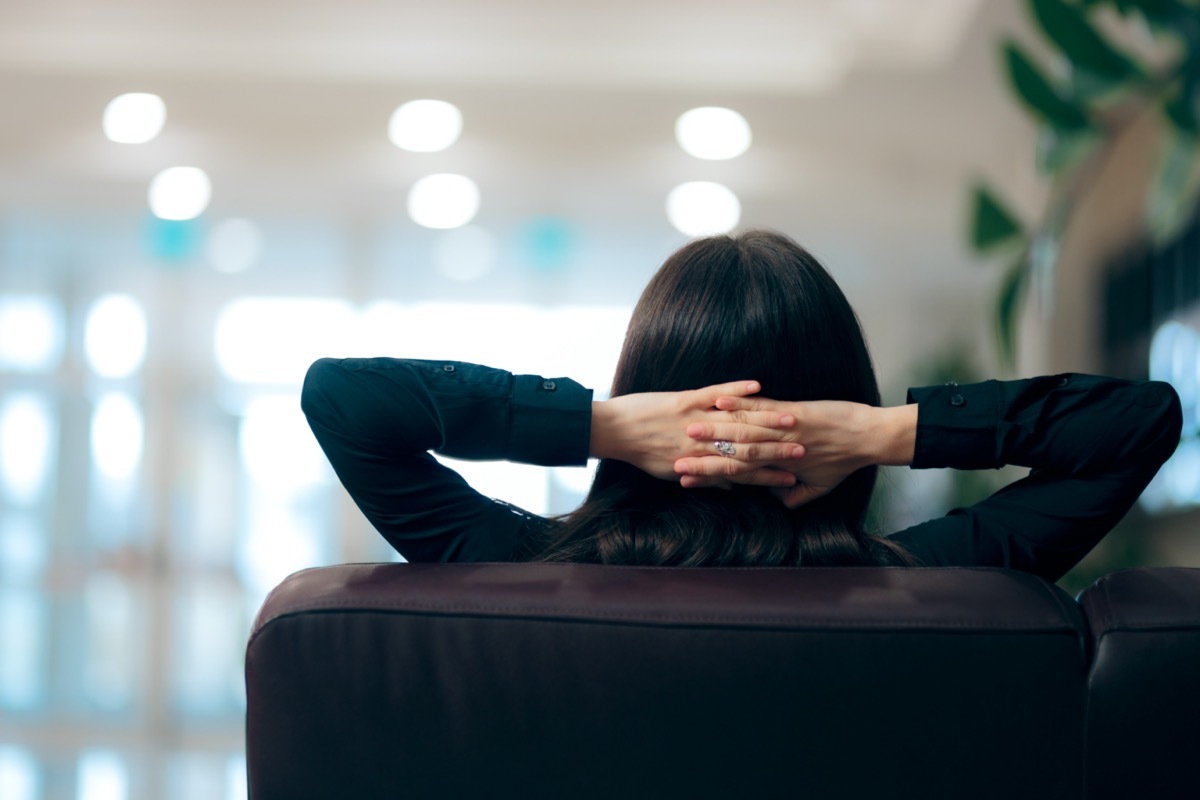 Relaxed Woman Sitting on a Couch in Waiting Room