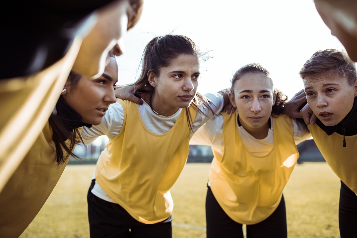 Close up of a female soccer team huddling for a motivational speech