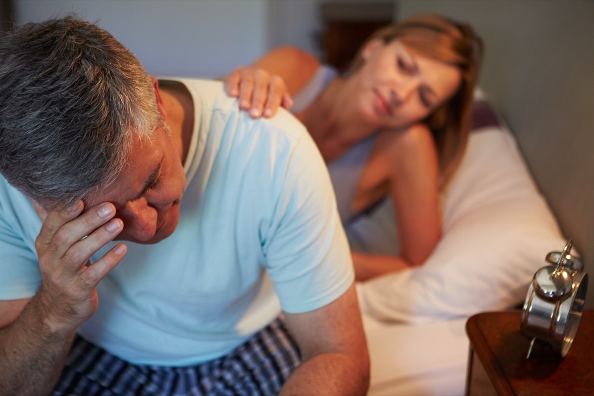 Man stressed in bed