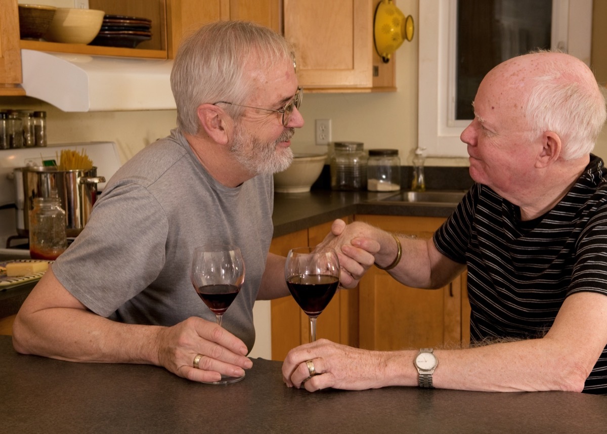 Gay couple having a serious conversation over wine