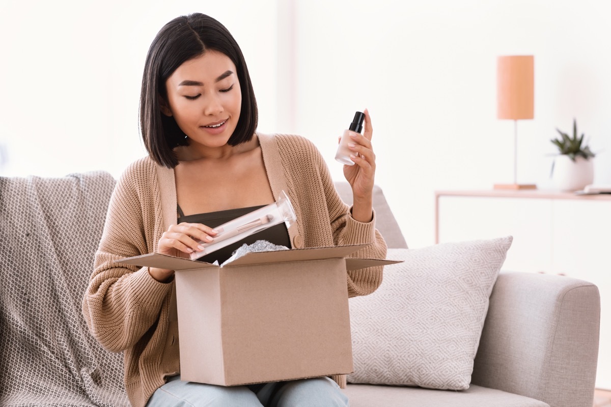 woman opening package with beauty supplies