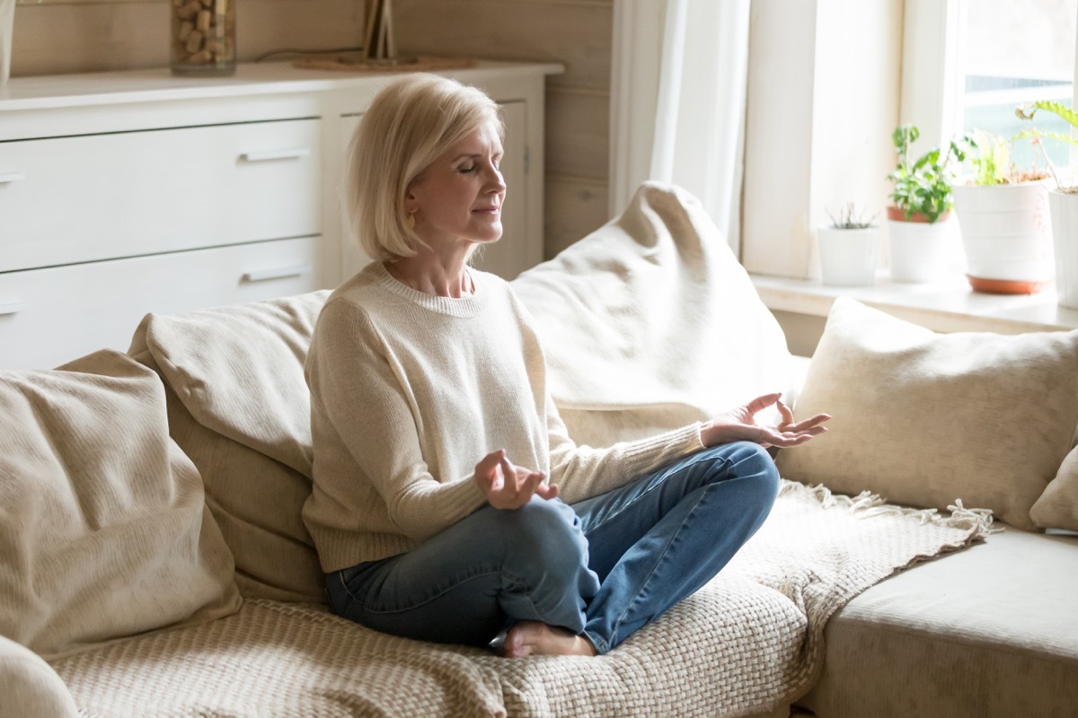 Woman meditating on her couch