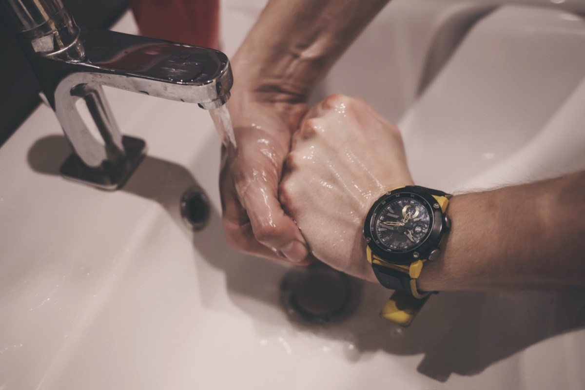 Close-up man washing his hands with soap