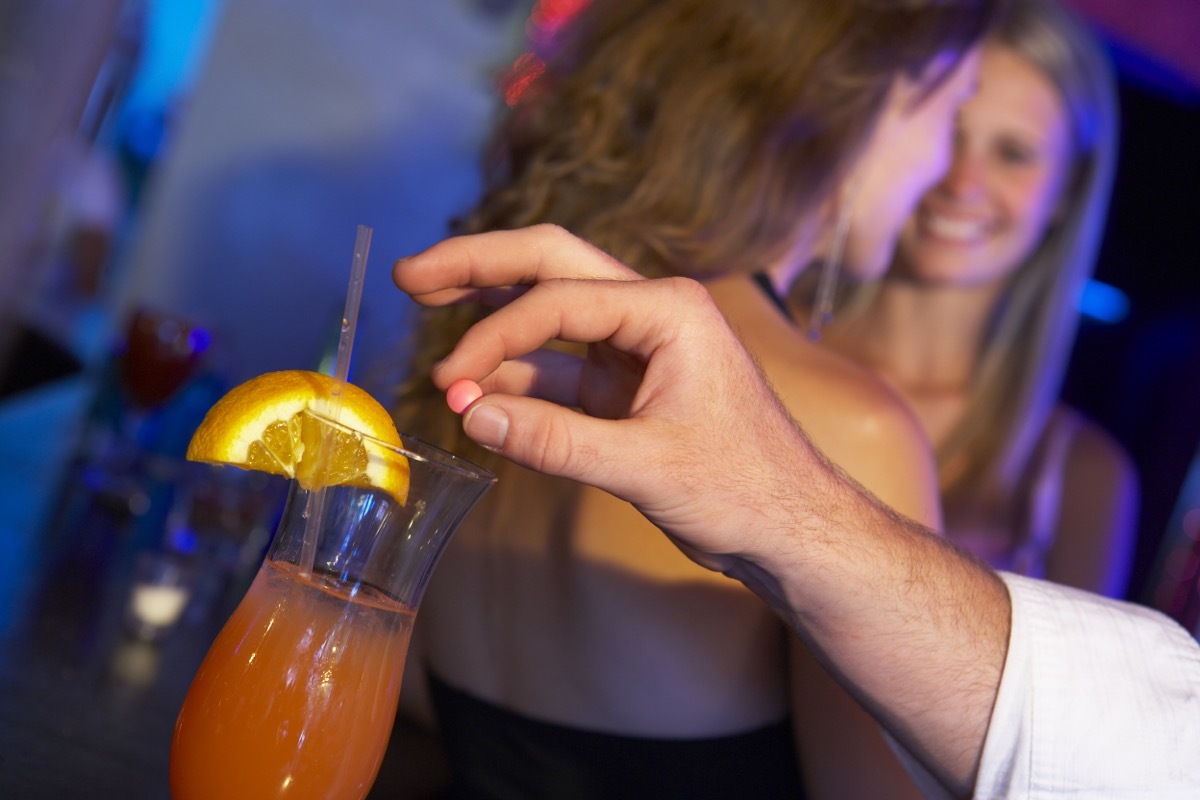 drink being spiked at a bar