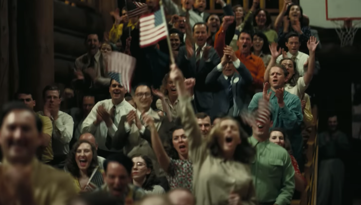 A crowd waving American flags in 