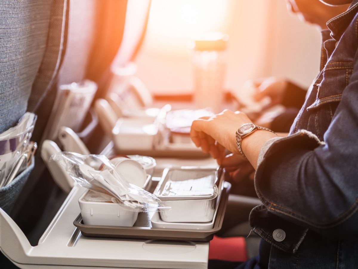 two women opening airplane food trays