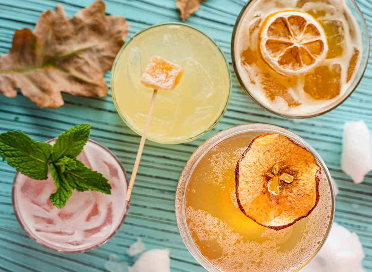 overhead view of colorful cocktails on picnic table