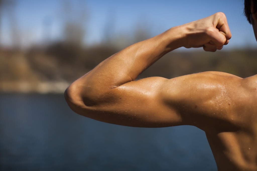 man slexing his arm muscle, ways your body changes after 40